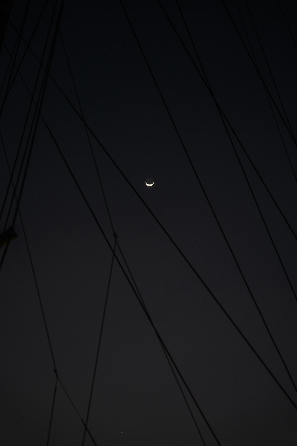 the moon and venus are seen through the power lines