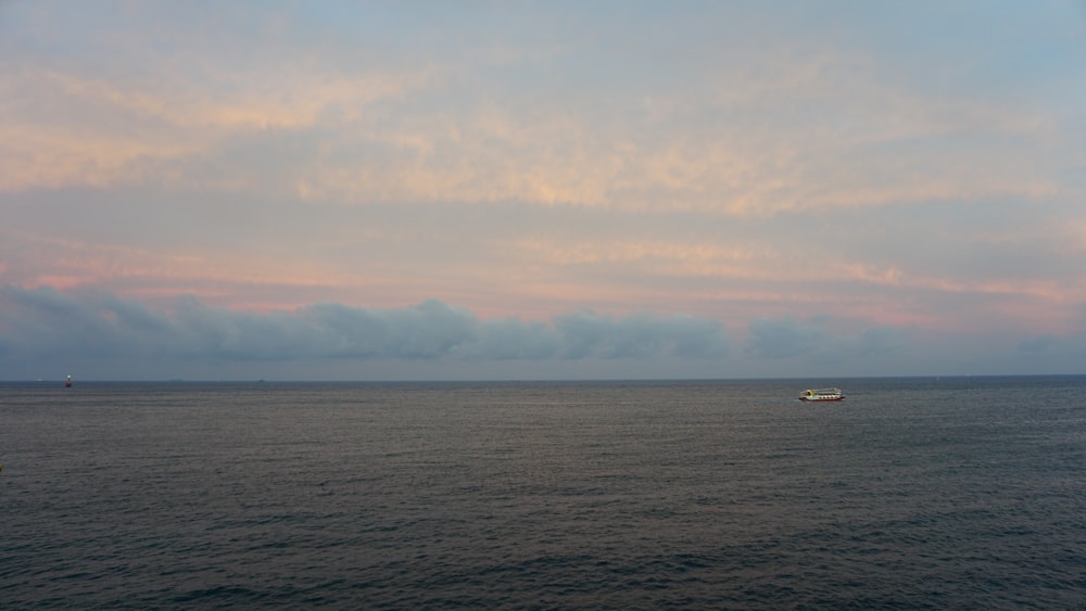 a boat floating on top of a large body of water