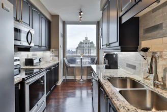 Before and after images of a stylish kitchen remodel in a city apartment.