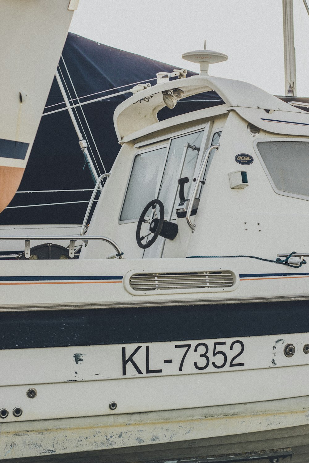 a white and black boat is docked in the water