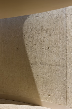 Close-up of textured concrete wall with subtle shadows enhancing depth