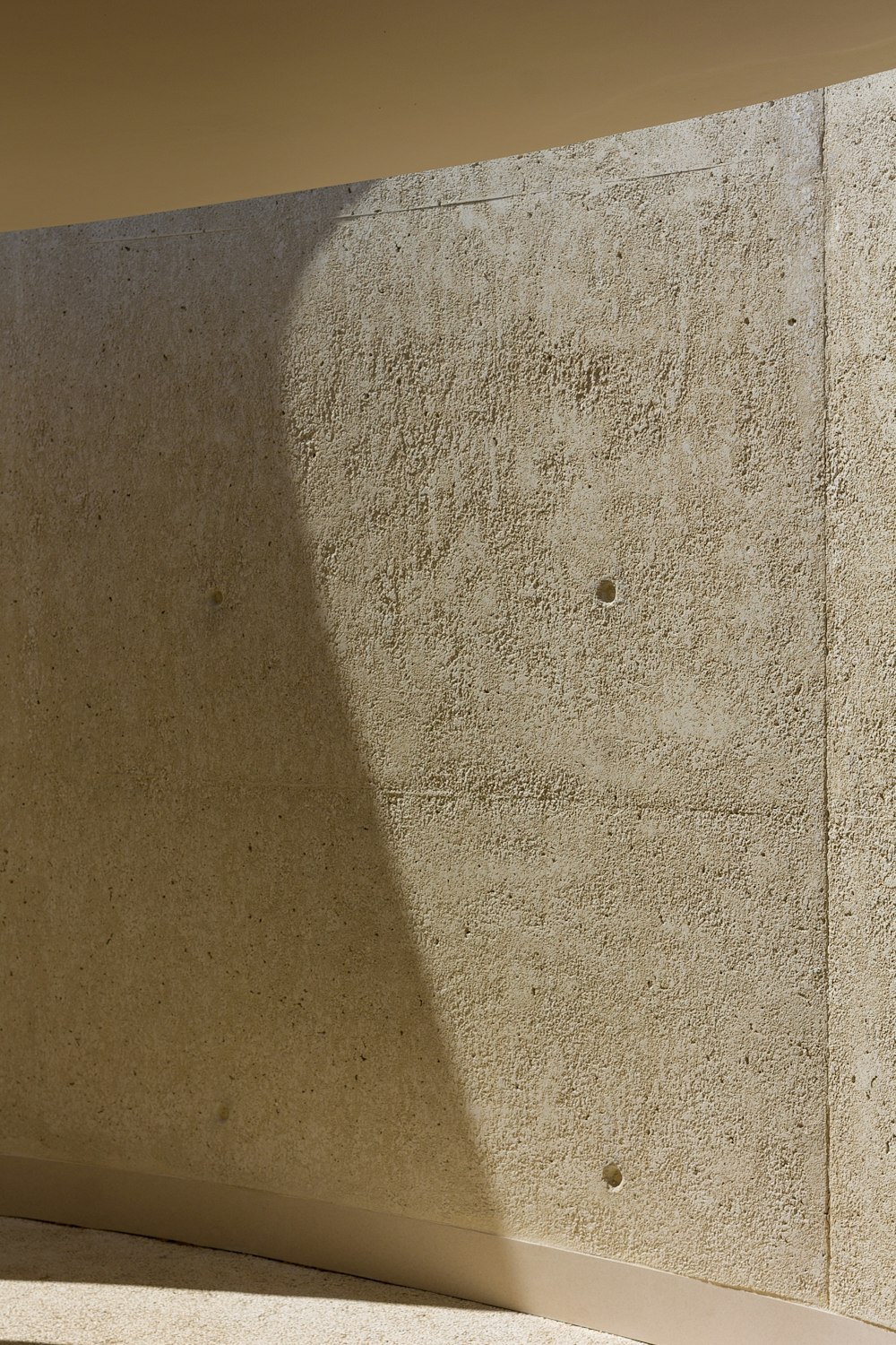 the shadow of a person sitting on a bench