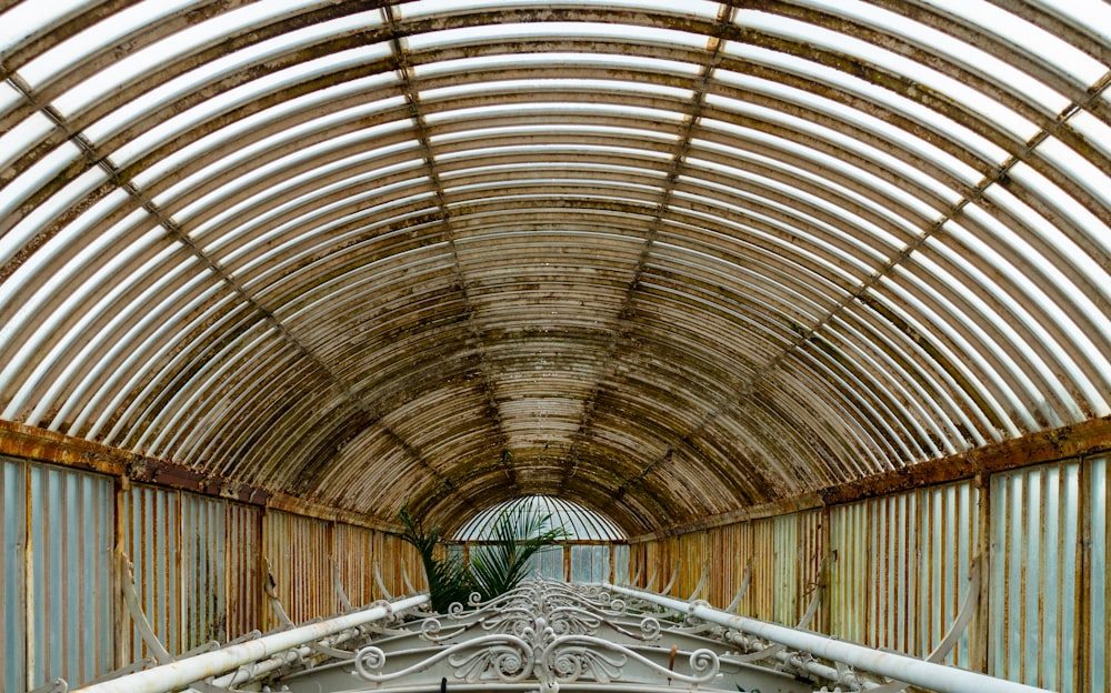 a tunnel with a metal fence and a bird cage