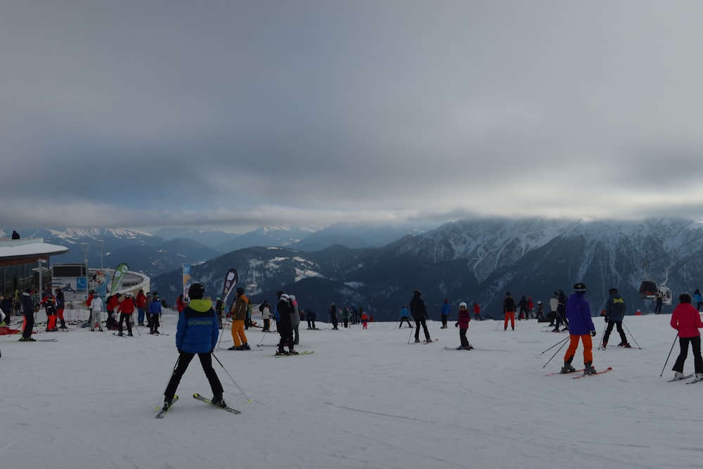 a group of people skiing on a snow covered slope