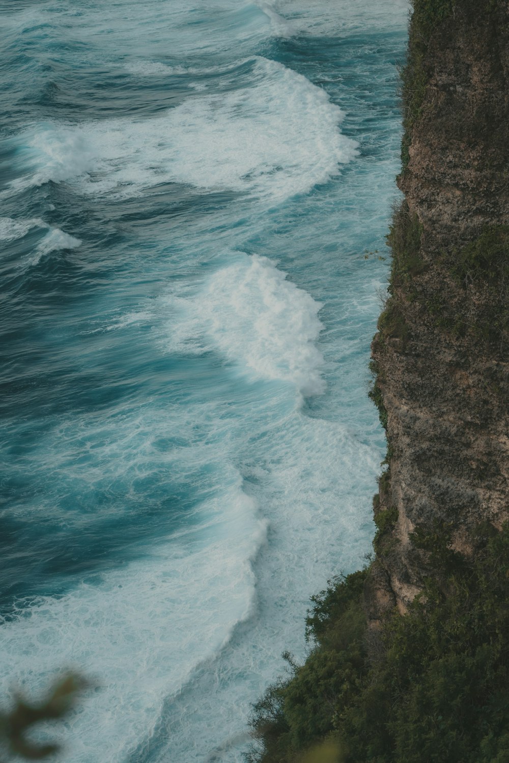 a person standing on a cliff overlooking the ocean