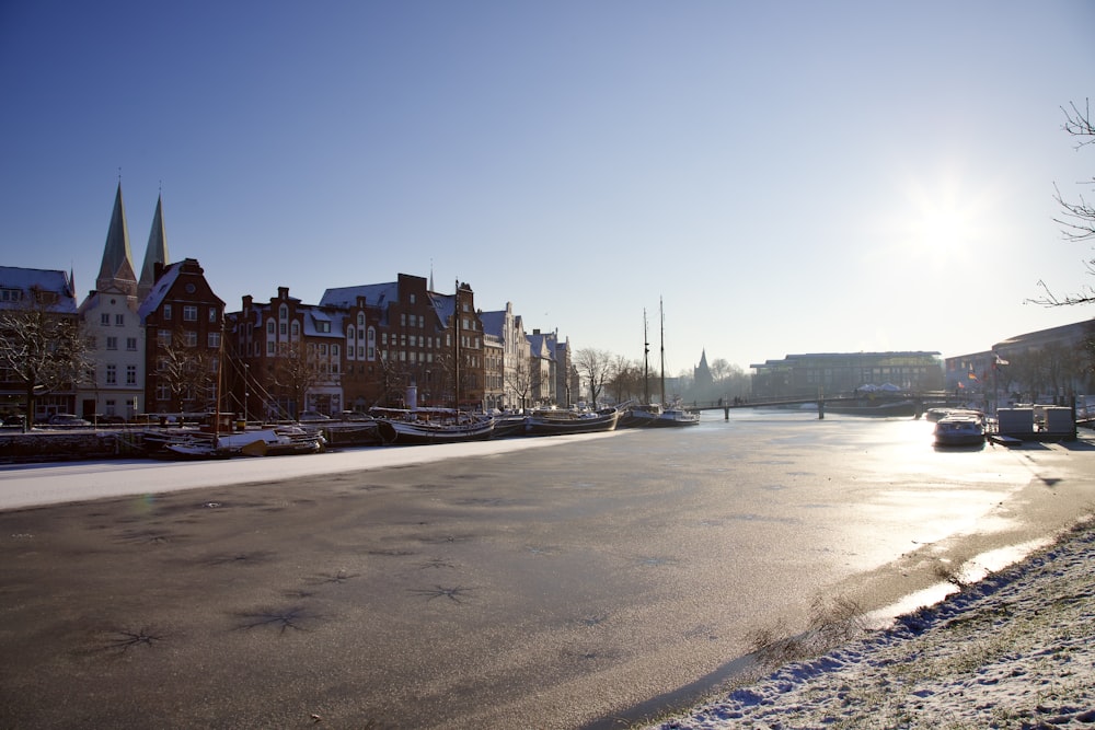 the sun is shining on a snowy street