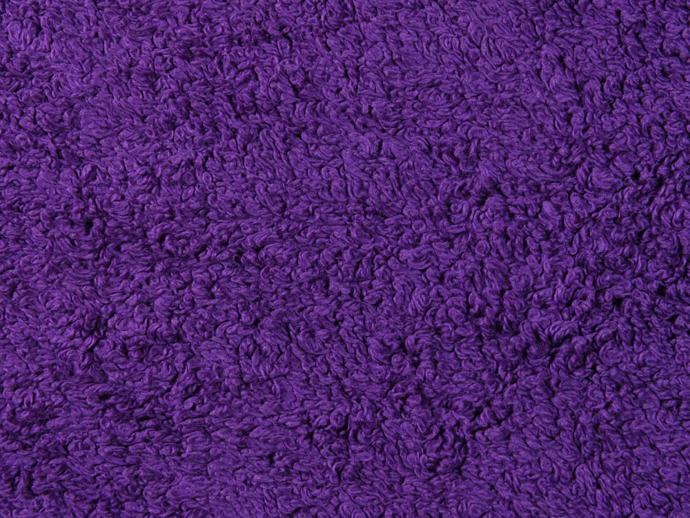 a close up view of a purple rug