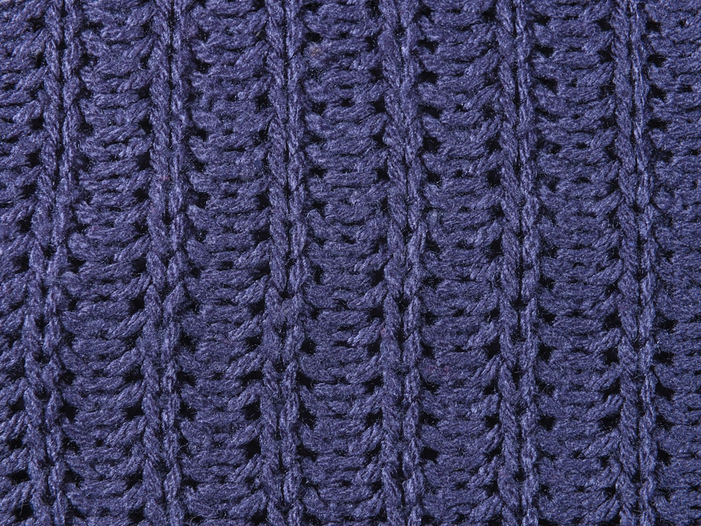 a close up of a blue knitted blanket