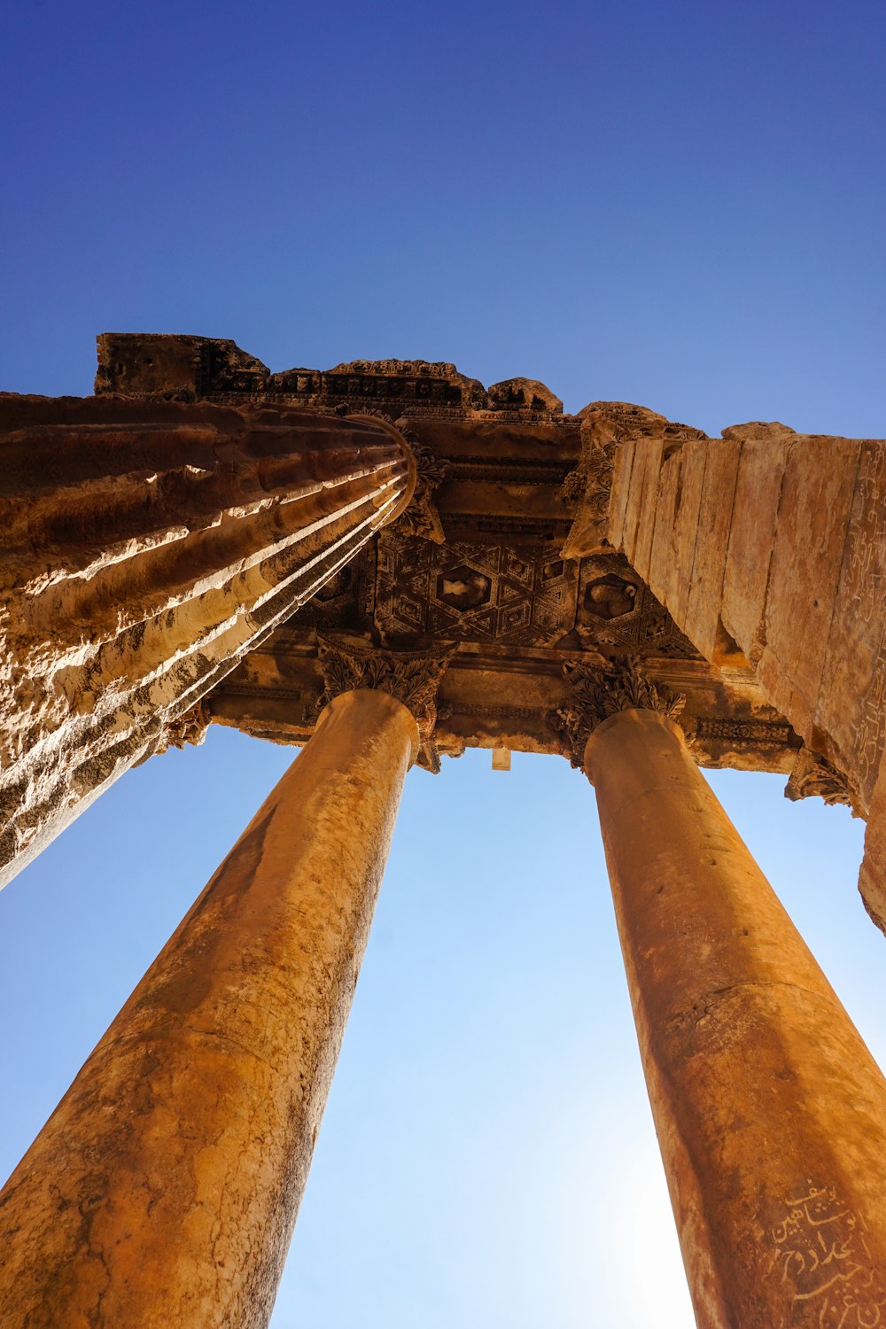 looking up at the pillars of a roman temple