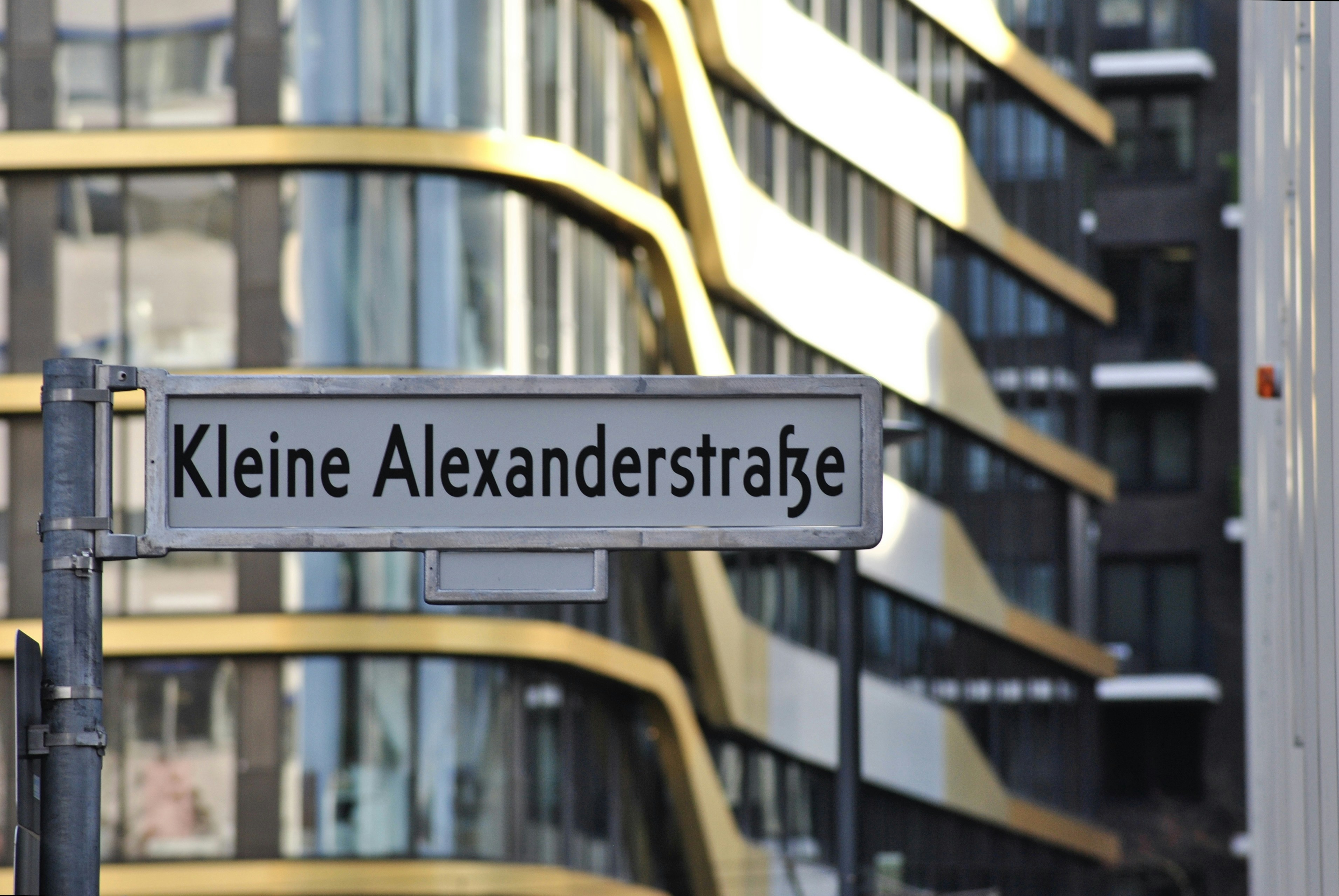 a street sign in front of a tall building