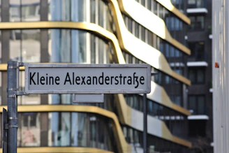 The exterior of mys on Alexanderstr 74, with a welcoming sign and a glimpse of the bustling street.