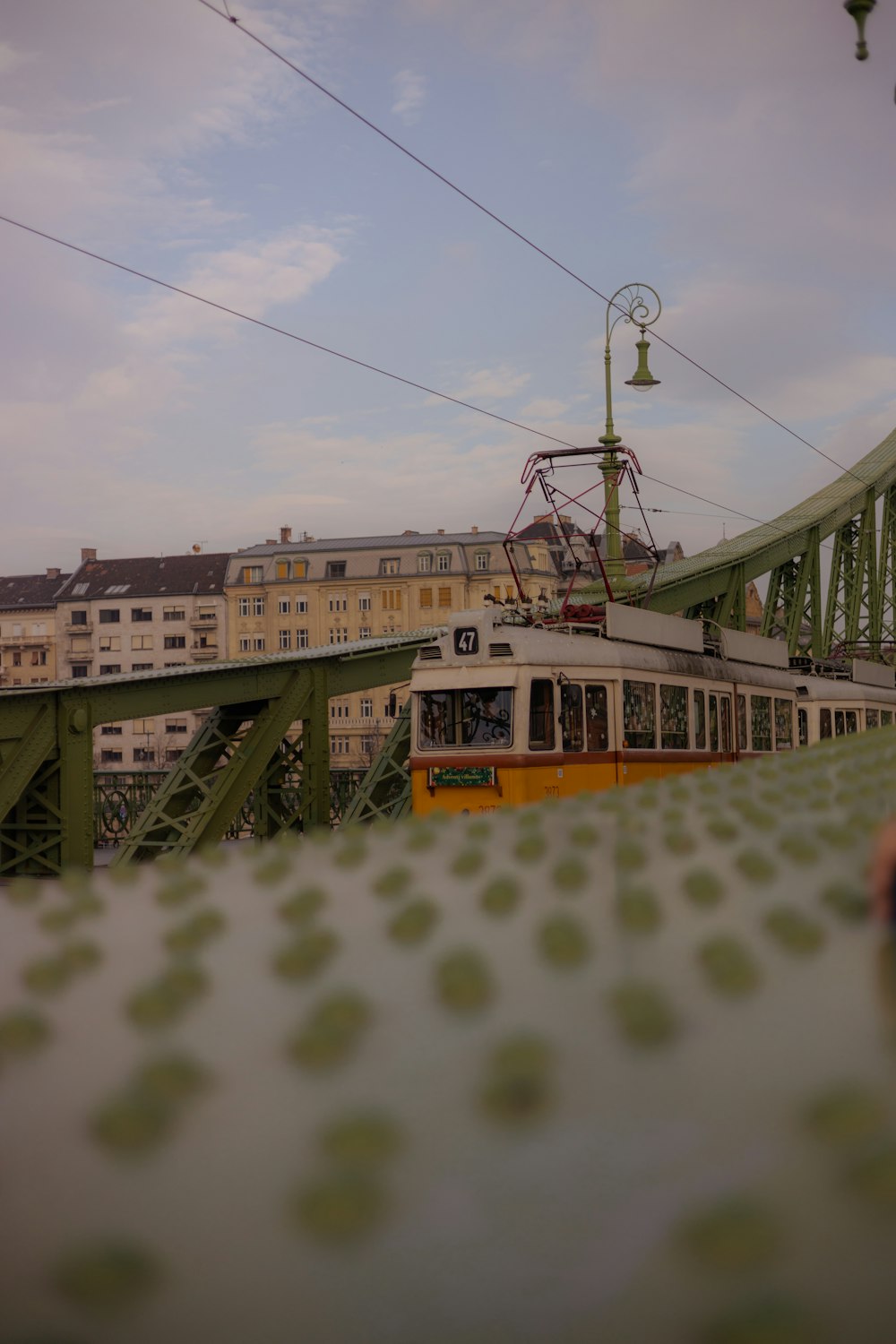 a train traveling over a bridge next to tall buildings