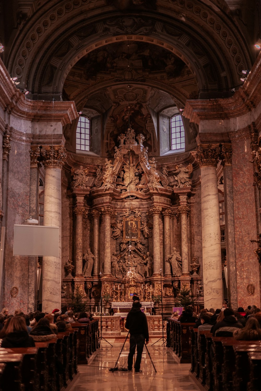 a man standing in a church with a cane