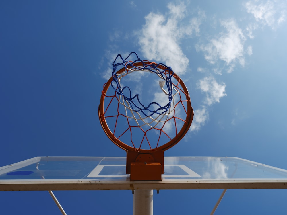 a basketball hoop with a blue sky in the background