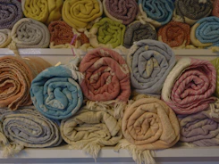 Close-up of colorful textiles neatly stacked in a warehouse