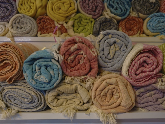 Close-up of colorful textile products neatly arranged on a wooden table