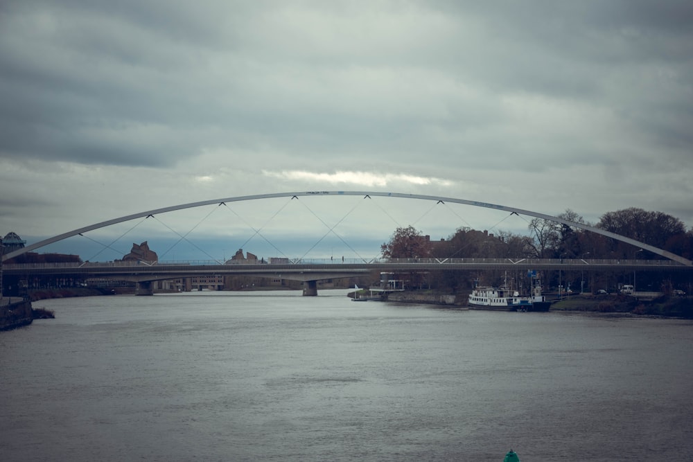 a bridge over a river with a green fire hydrant