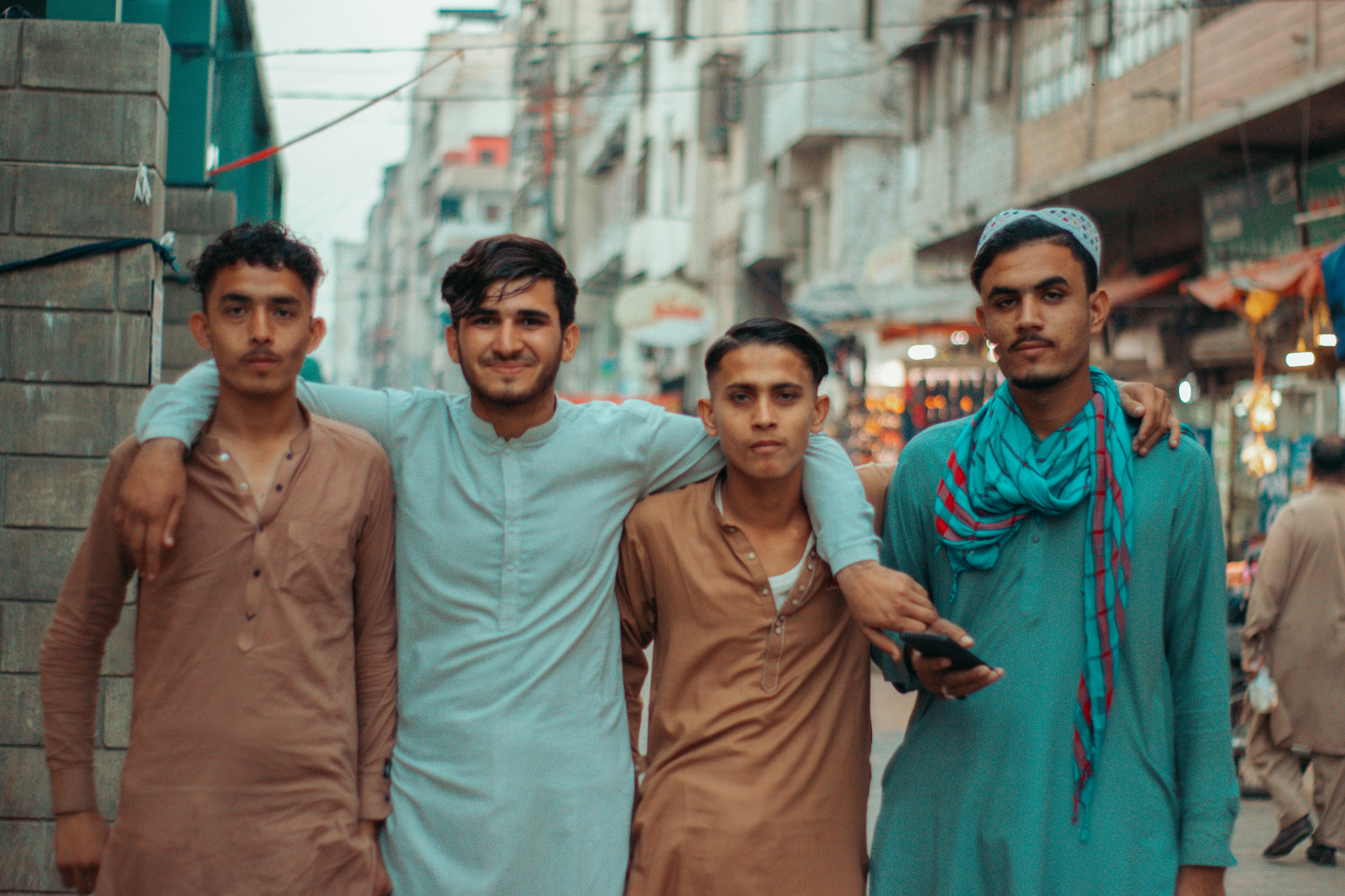 a group of men standing next to each other on a street