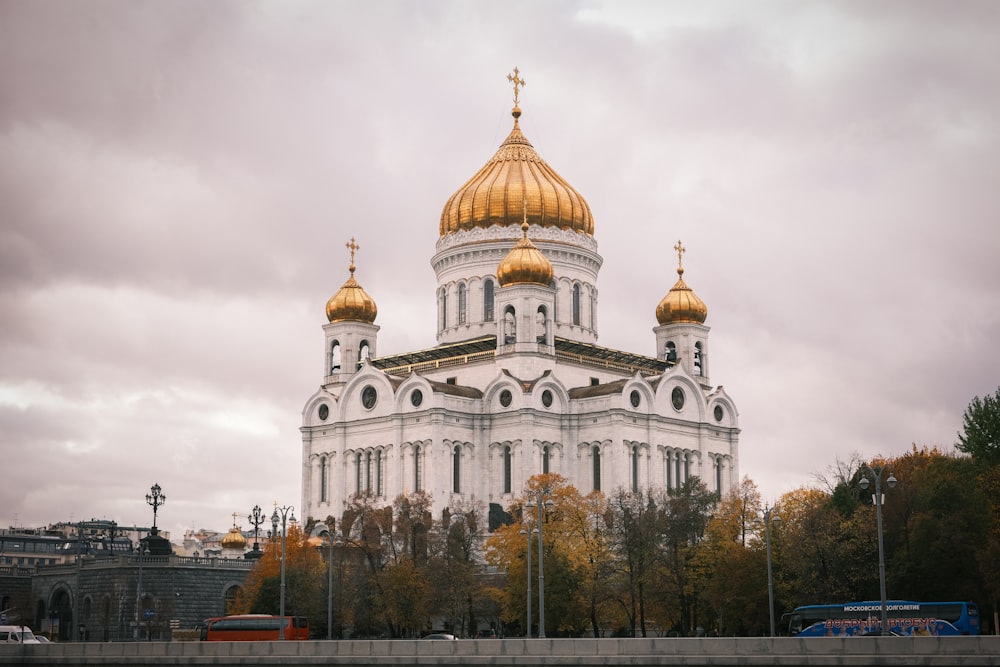 a large white building with gold domes on top