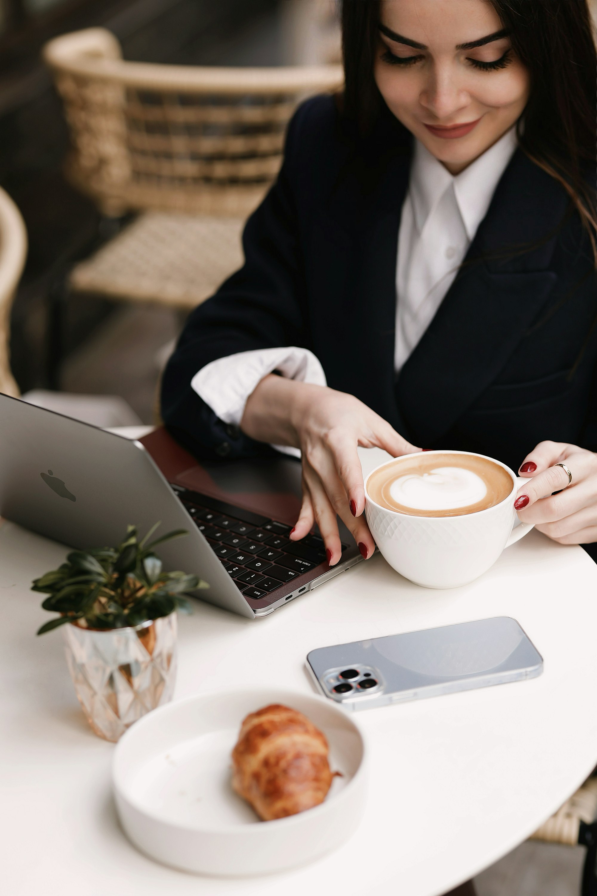 A freelancer taking a sip of coffee happy that she is in charge of her freedom