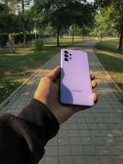 A person using a smart gadget while jogging in a park.