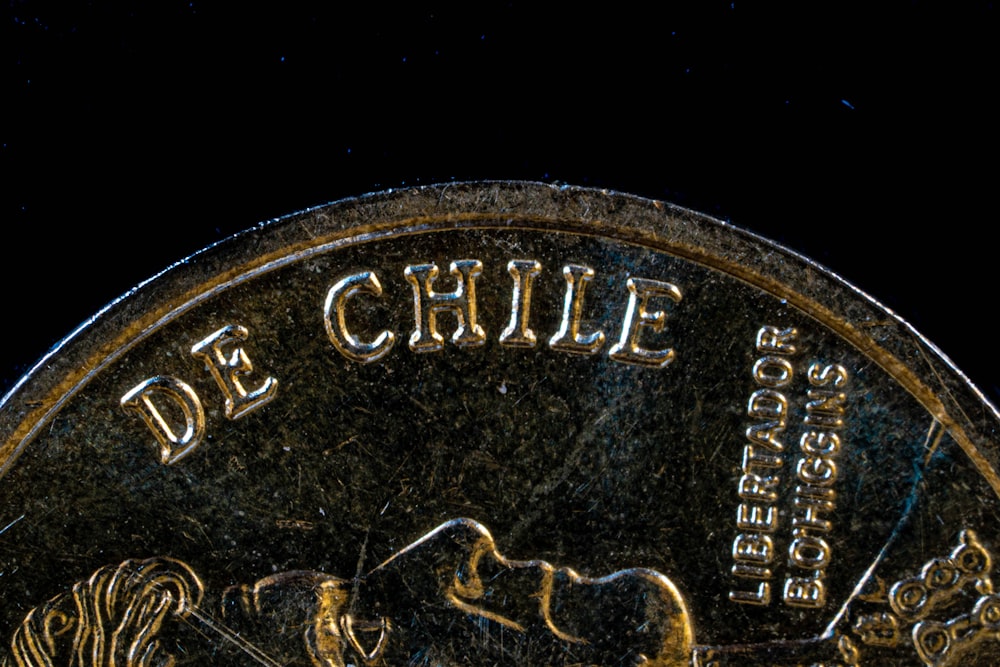 a close up of a coin on a black background