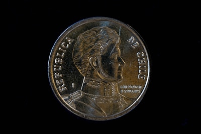 a close up of a coin on a black background