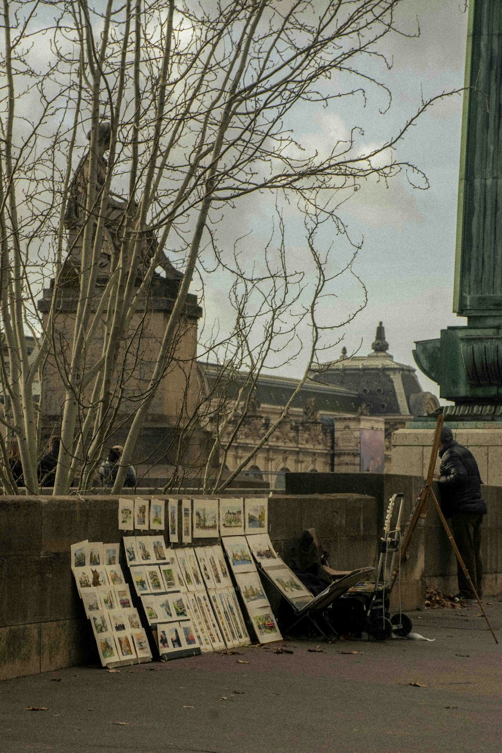 a man standing next to a bunch of newspaper