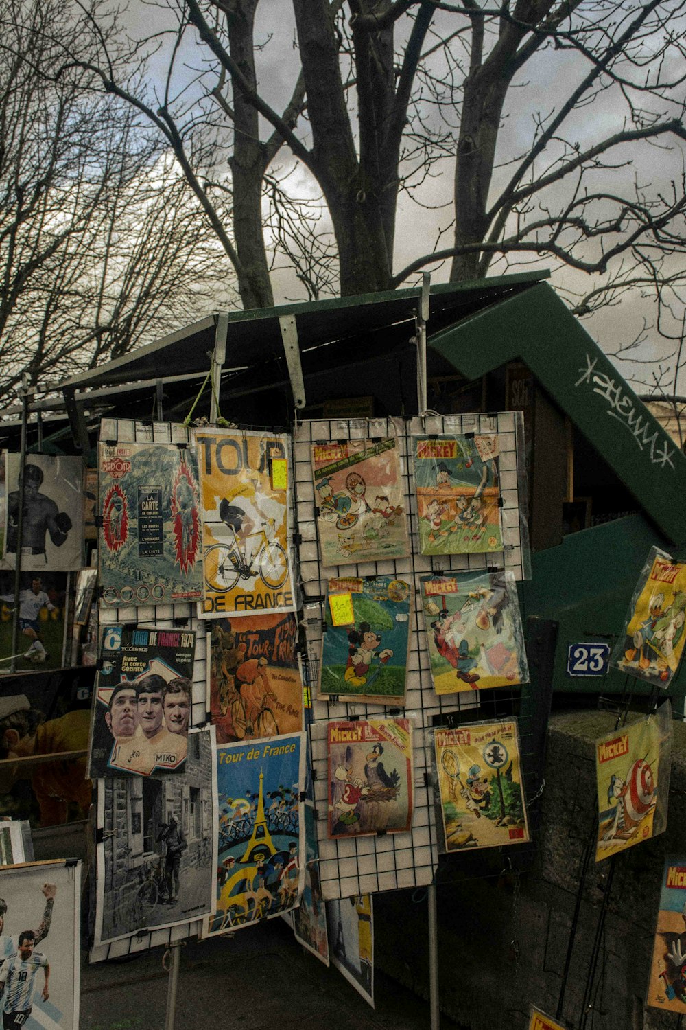 a bunch of posters are hanging on a fence