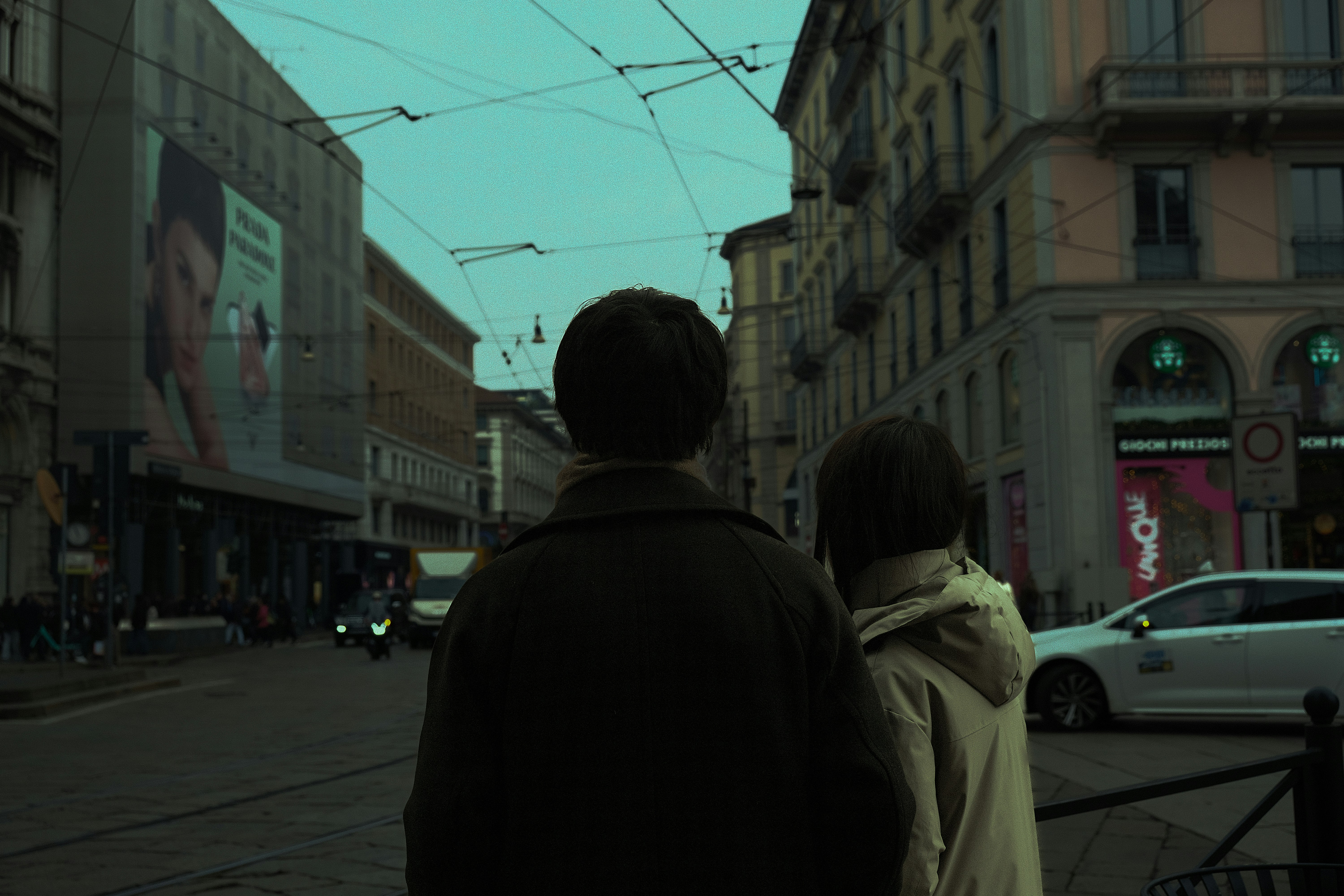 a man and a woman walking down a street