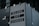 A large sign with bold text reads 'Milano City Studios'. The sign is attached to a modern building with glass panels and metallic fasteners. It appears to be part of a production or event location.
