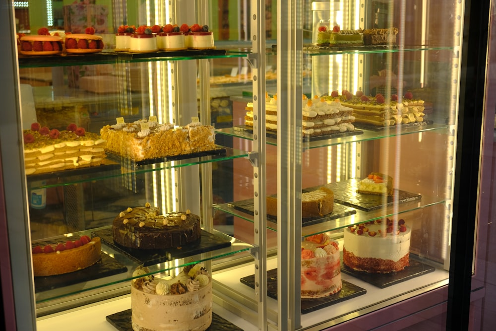 a display case filled with lots of different types of cakes