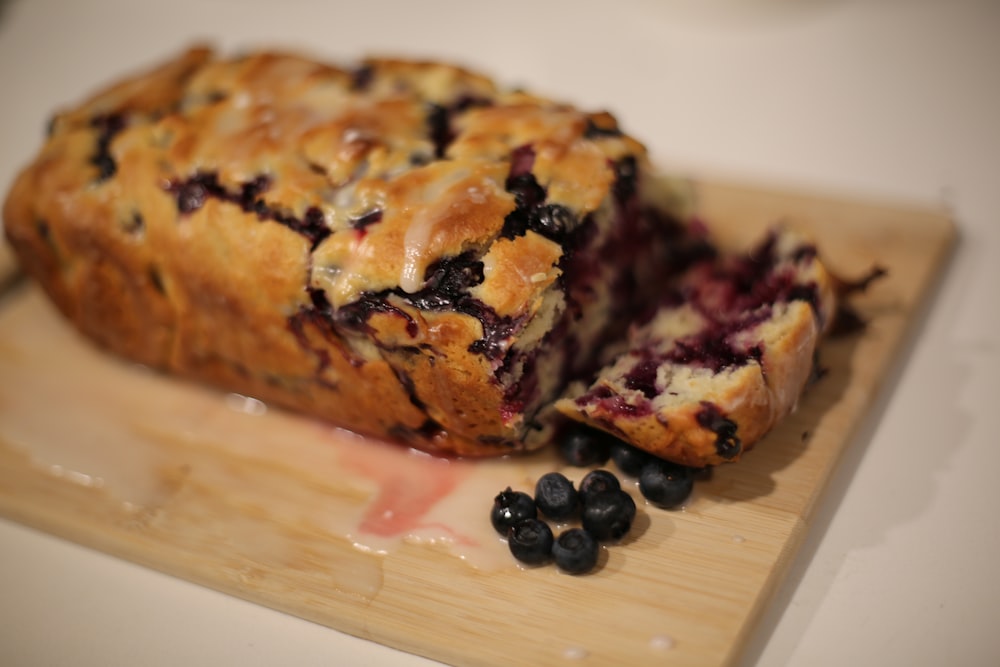 a loaf of blueberry bread on a cutting board