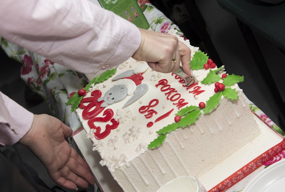 a person cutting a cake with a knife