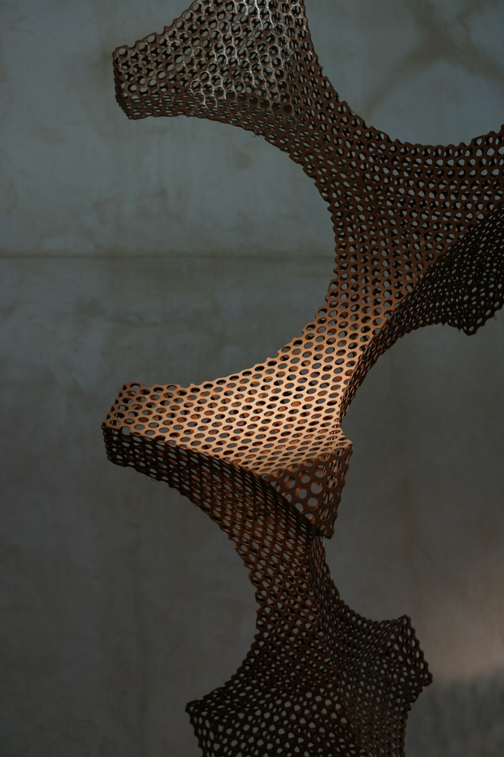 a sculpture made of metal mesh sitting on top of a table