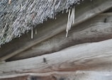 A close-up drone image showcasing the intricate roof patterns of an old barn.
