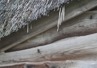 A close-up drone image showcasing the intricate roof patterns of an old barn.