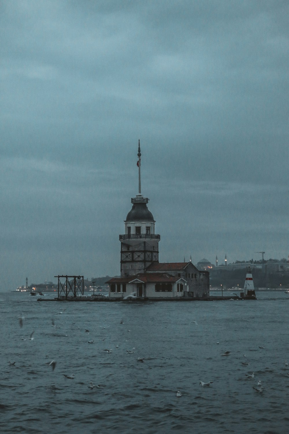 a large body of water with a building in the middle of it