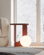 Cozy living room corner featuring a modern lamp and natural wood furniture