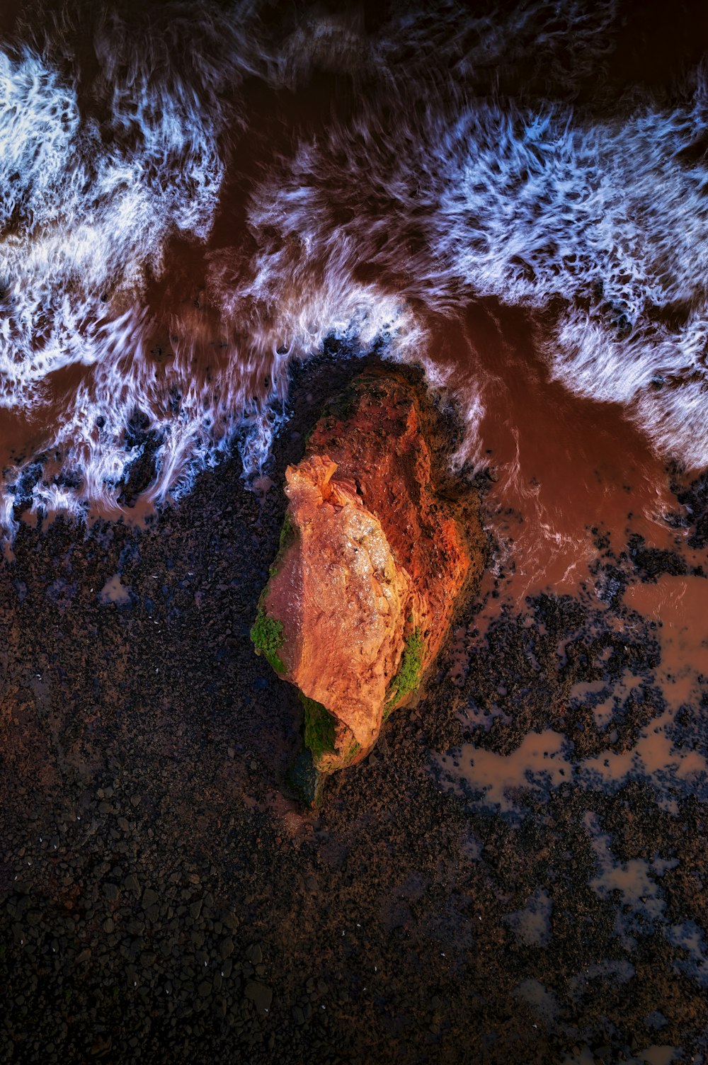 a rock in the middle of a body of water