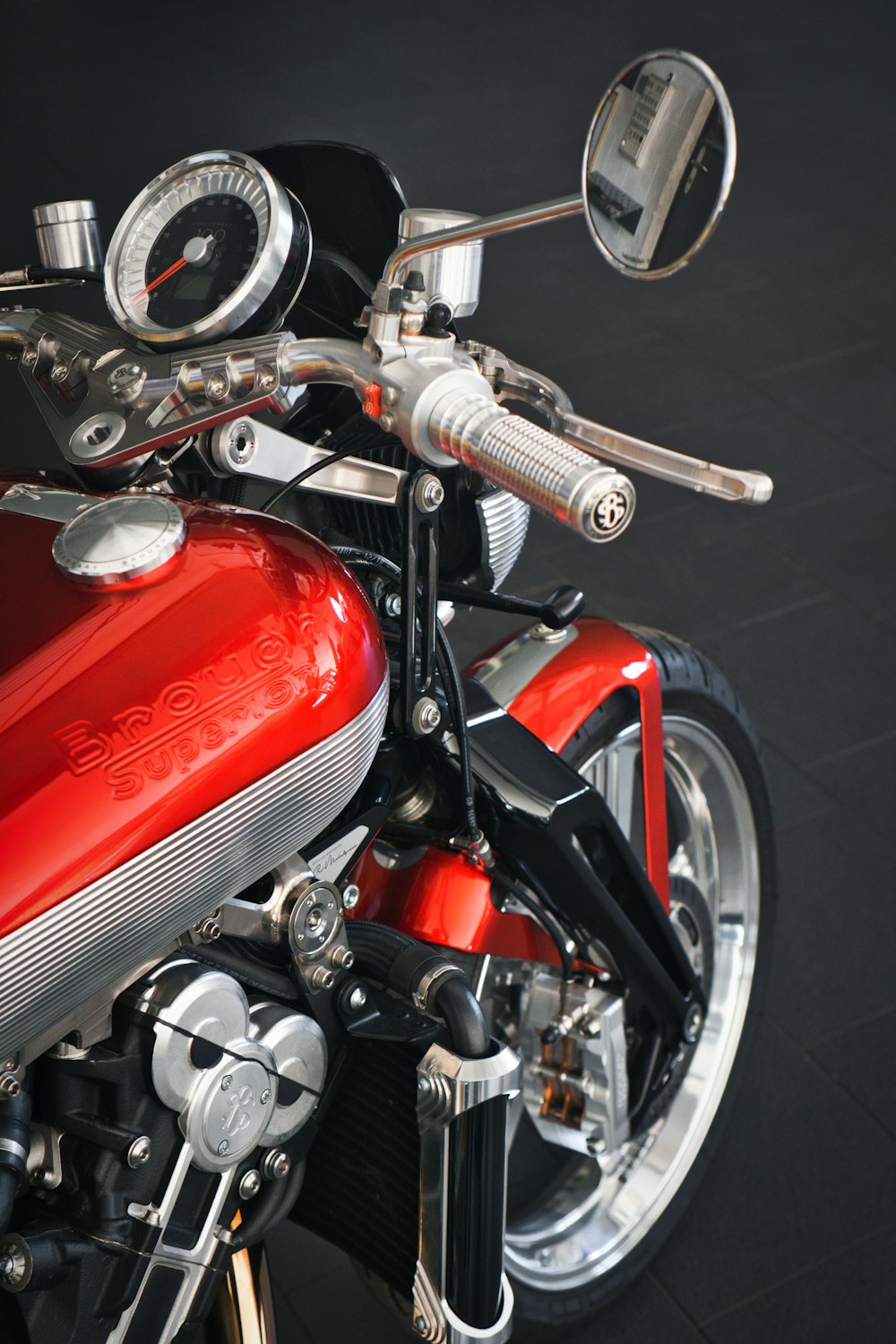 a close up of a red motorcycle on a black background