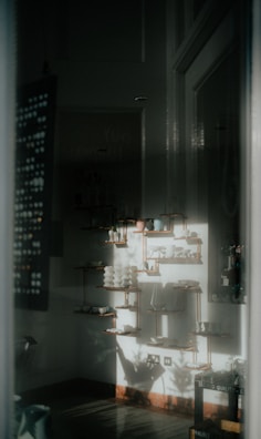 A softly lit interior showcasing a curated collection of bespoke accessories on display.