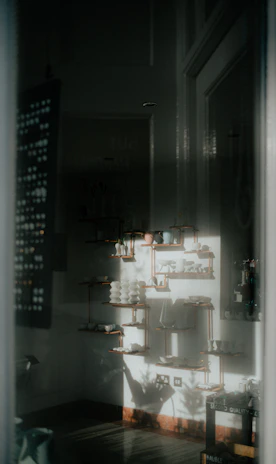 Close-up of textured ceramics and soft textiles arranged thoughtfully on a wooden shelf.