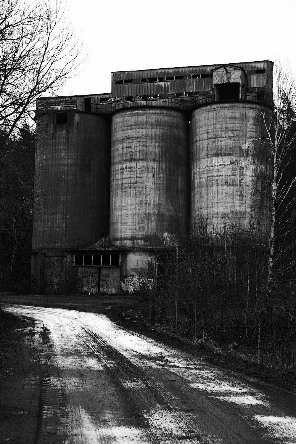 a black and white photo of an old grain silos