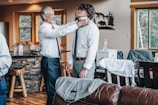 Groom adjusting his tie in a modern, sunlit room before the ceremony.