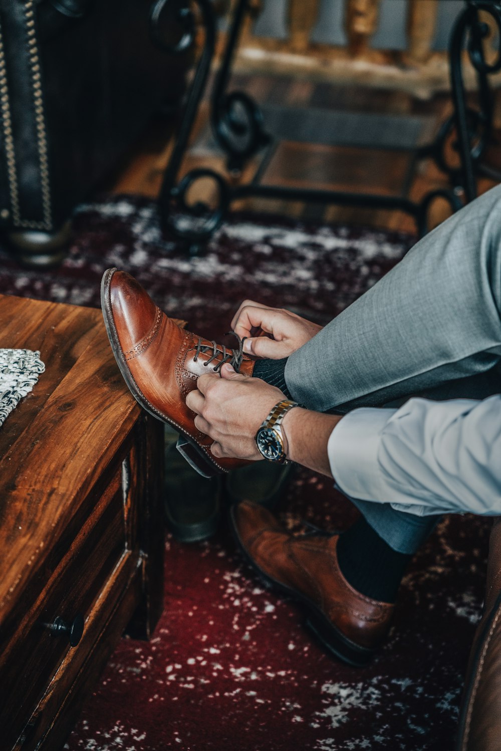 a man putting on his shoes in his living room