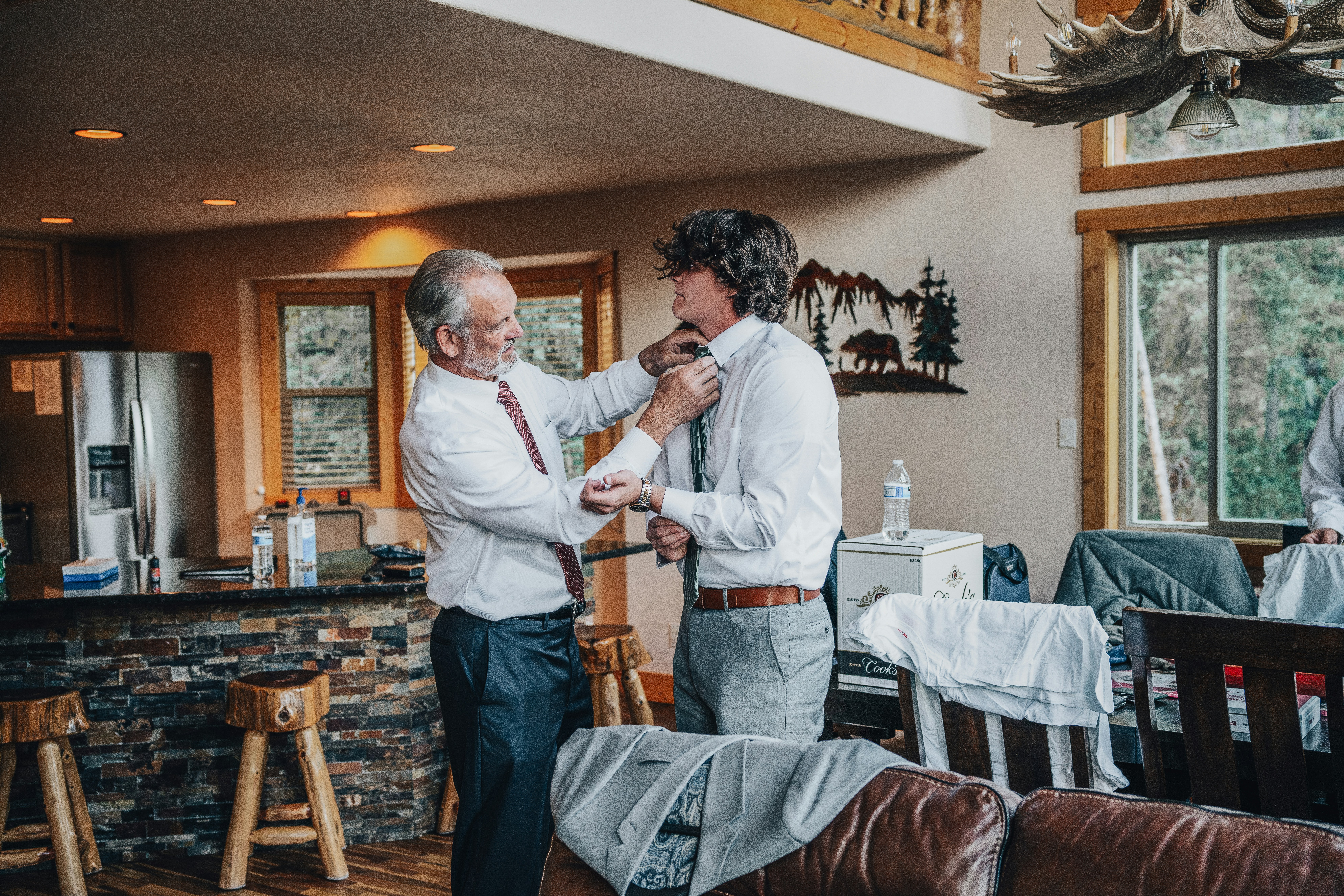 A friendly, professional electrician in uniform, smiling and shaking hands with a homeowner inside a well-lit living room, conveying trust and good communication. - best electrical installation bonita springs fl