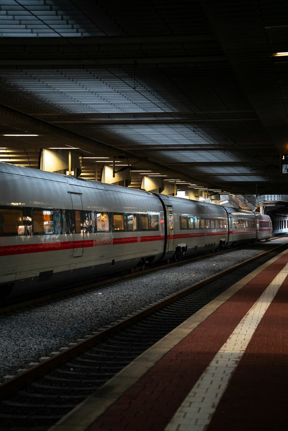 a train pulling into a train station at night