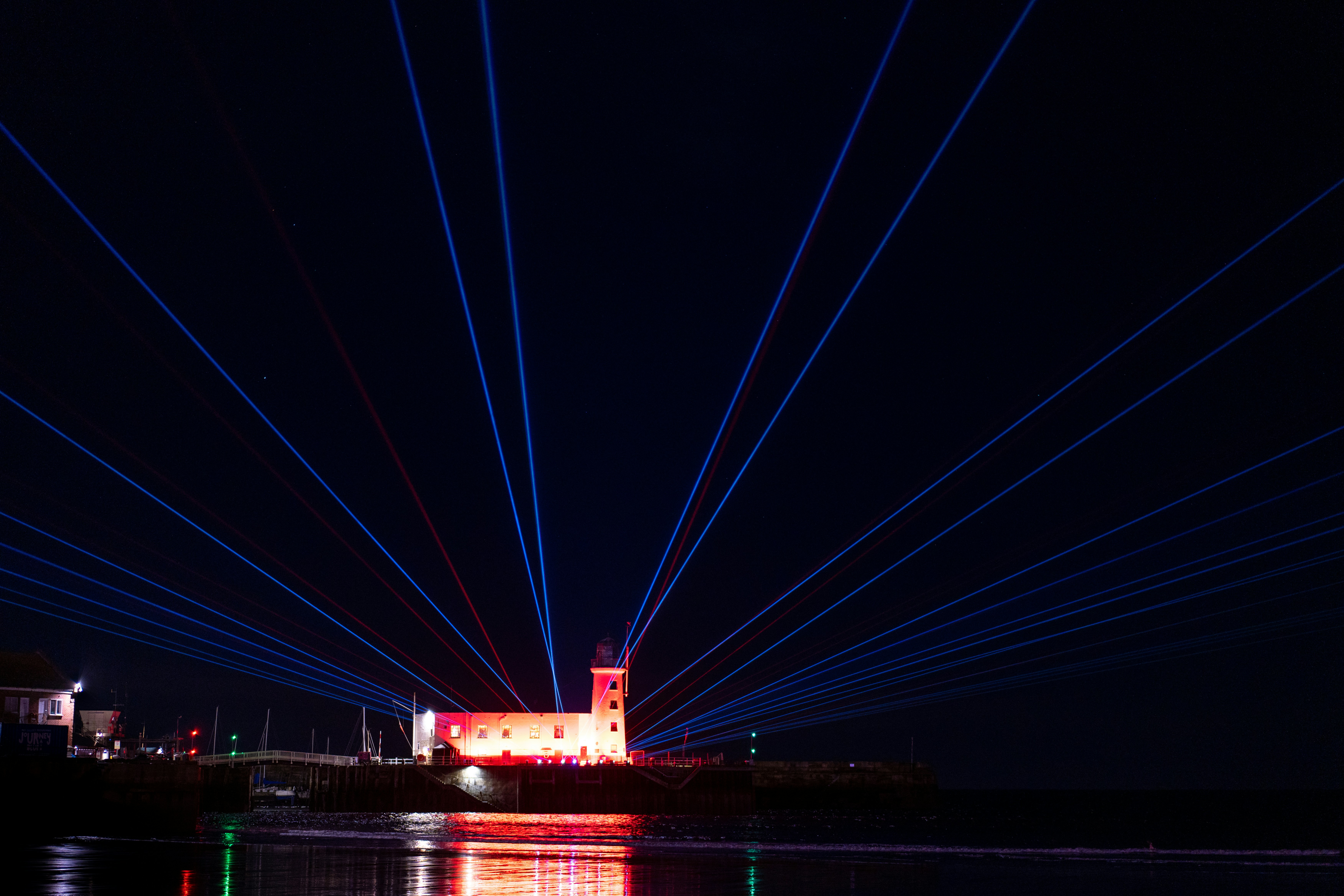 a long exposure photo of a lighthouse at night