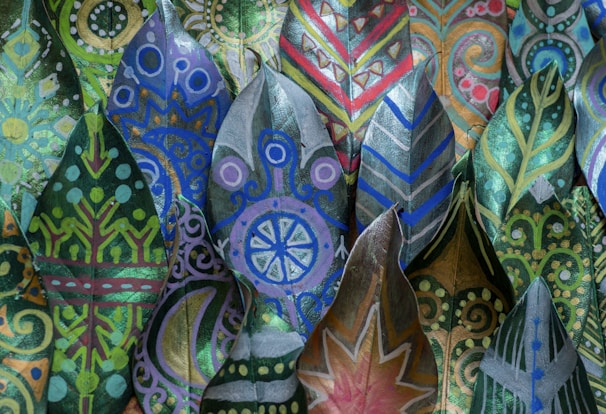 Brightly colored geometric designs typical of Mithila art, painted with fine brushwork on handmade paper.